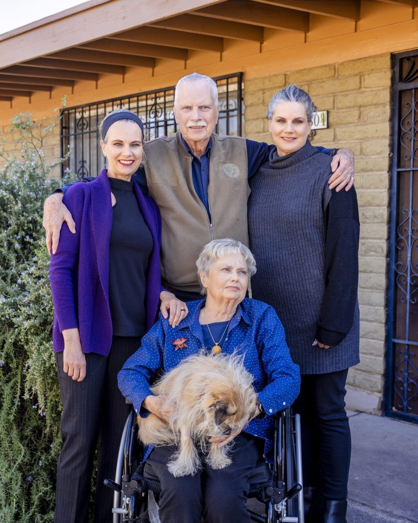 Four Slack family members gather close together with a dog for a Mother’s Day family portrait.
